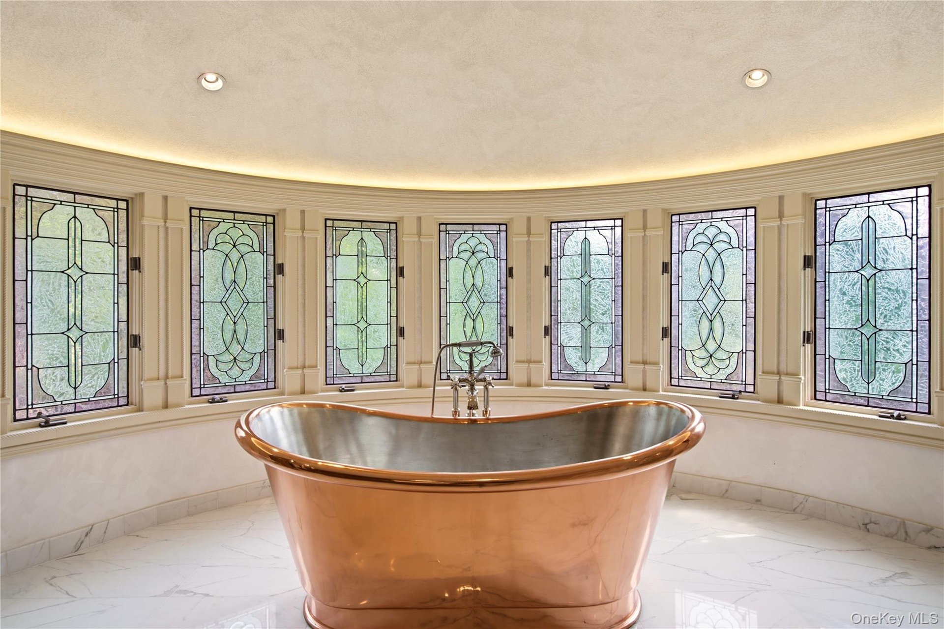 Striking freestanding copper soaking tub, surrounded by stained-glass windows.