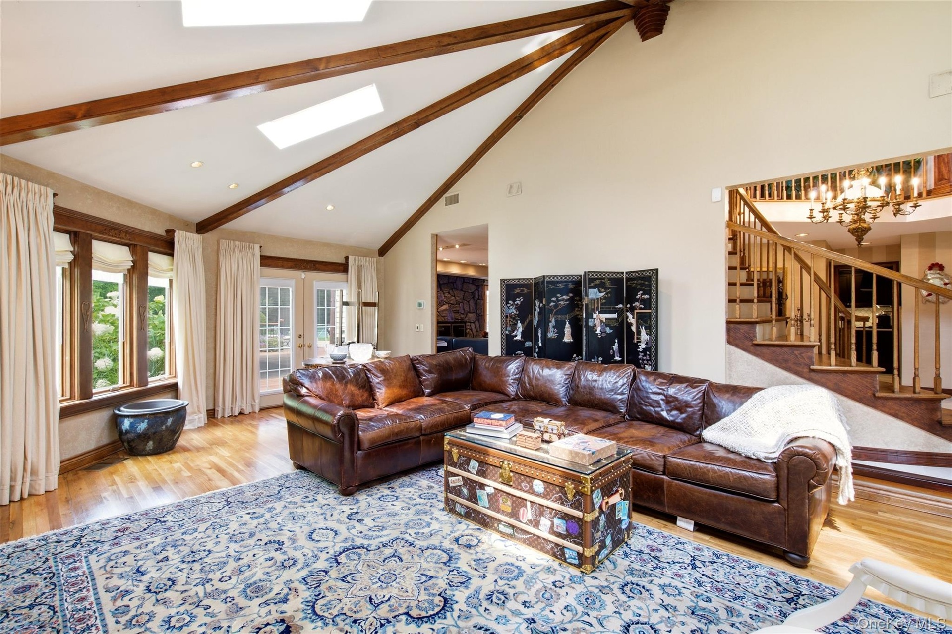 Vaulted ceiling with exposed wood beams and skylights