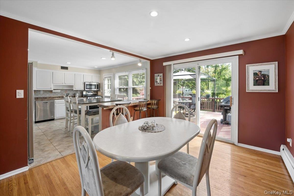 Formal dining room opens to your eat-in kitchen and sliders lead to the large deck.