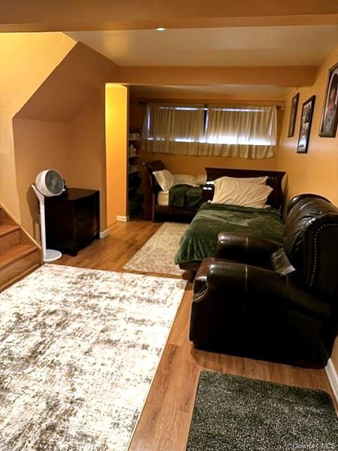 Wood-finish flooring throughout, recessed ceiling lighting, and built-in shelving