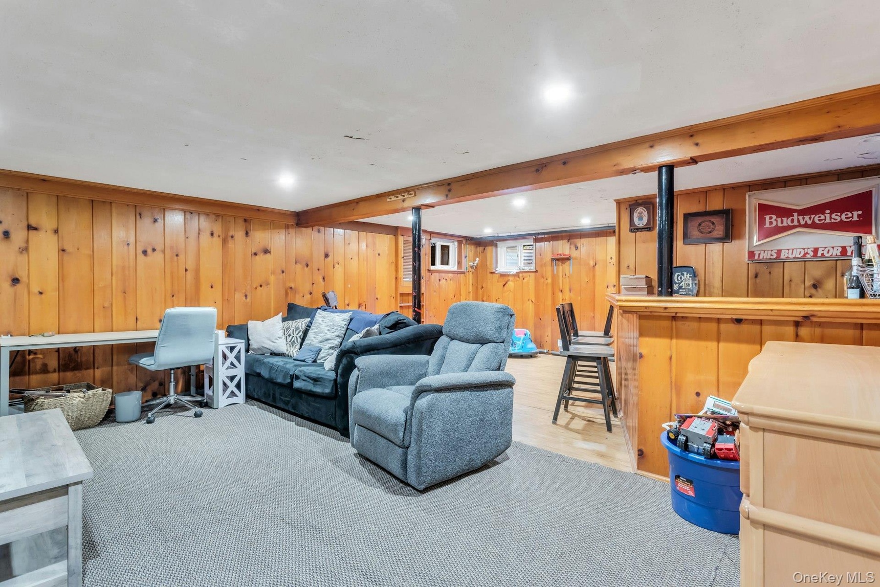 Wood paneling, recessed lighting, carpeted and wood-finish flooring, and a built-in bar