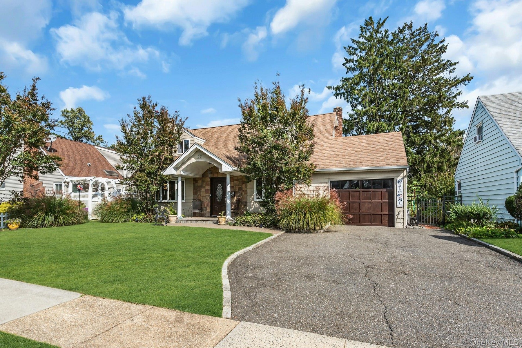 Gable roofline residence with stone veneer accents and a covered front porch entry