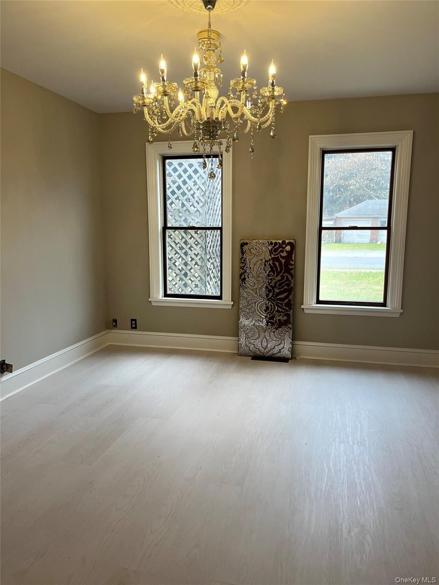 Light wood-finish flooring with crisp white baseboards
