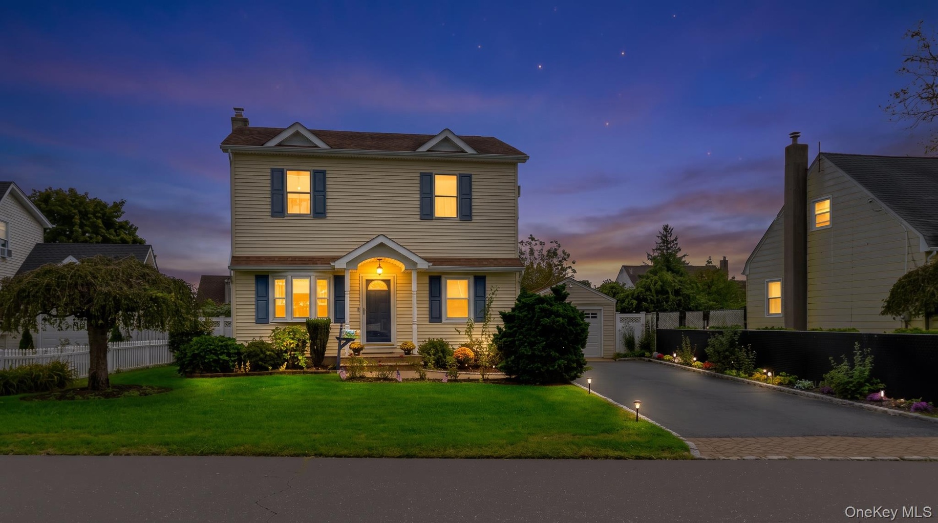 Two-story residence featuring siding exterior, an arched entry, and blue window shutters