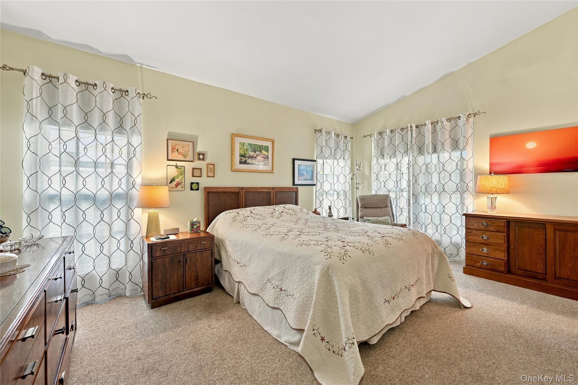 The Warm & Inviting, Well Sized Primary Bedroom Offers Beautiful Vaulted/Volume Ceilings, Upgraded Carpeting, Large Tri State Windows For Natural Ligh