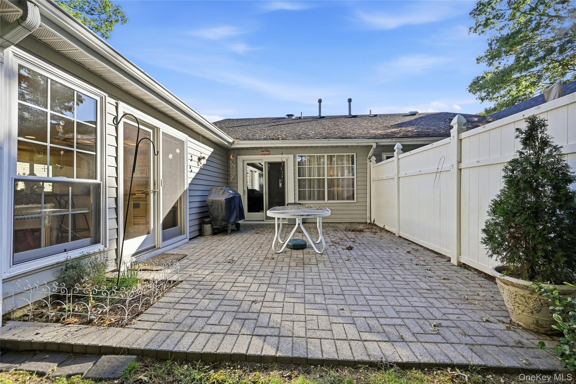 Off Of The Kitchen/Leisure Room & The Formal Living Room Is A Large Brick/Paver Patio With A Gardening Area/Space, And The Patio Overlooks The Beautif