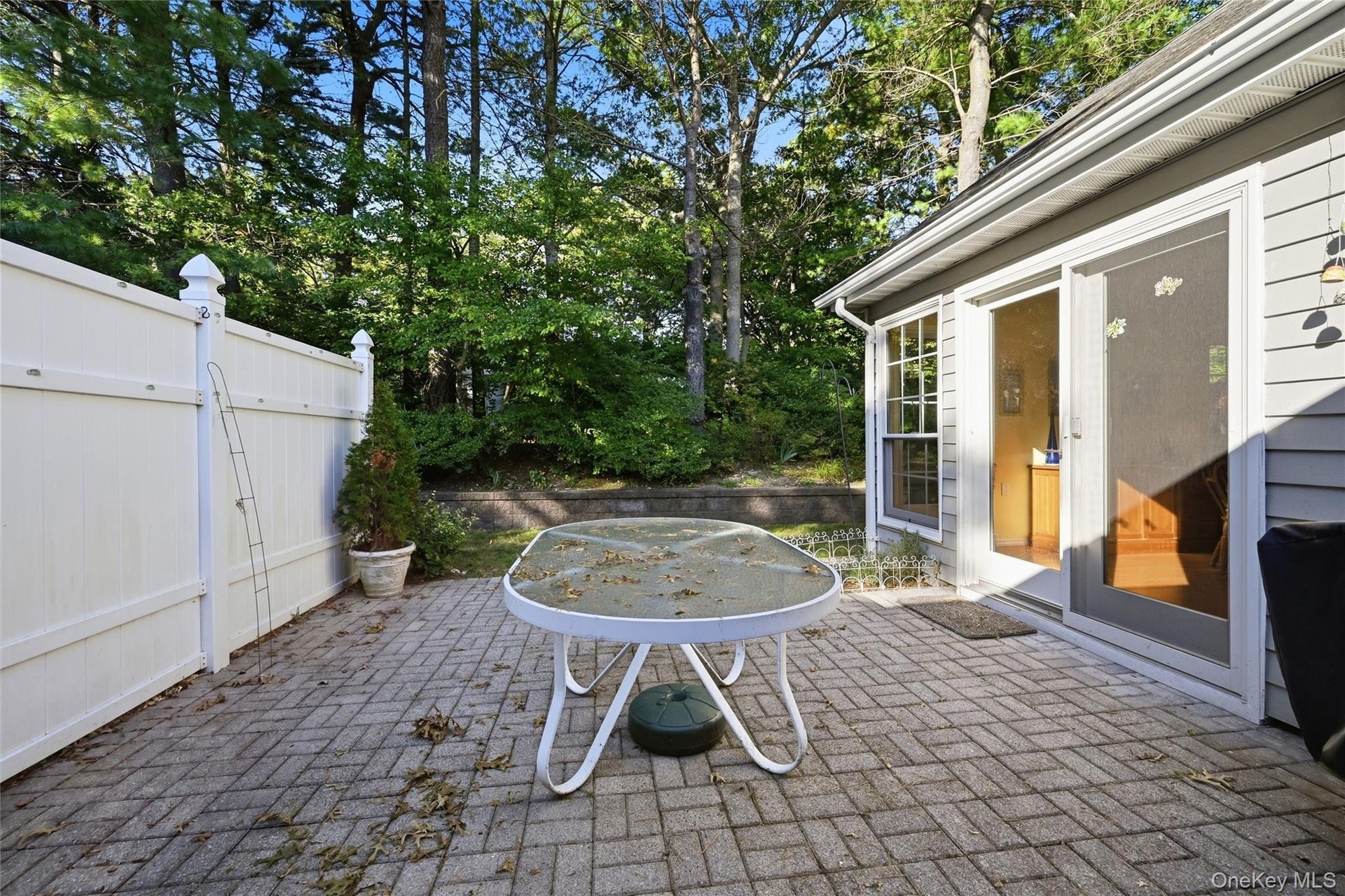 The Large Brick/Paver Patio Offers Ample Outdoor & Entertaining Space, Has PVC Privacy Fencing, And Overlooks The Beautiful Mature Landscape & Very Pr