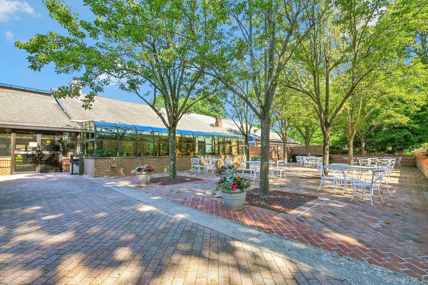 An Expansive Stunning Brick/Paver Patio Off The Back Of The Country Club Clubhouse & Beautiful Open Enjoyment Spaces.