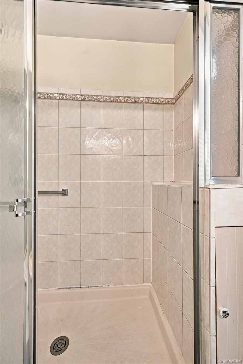 The Primary Bathroom Offers An Oversized Shower With Beautiful Updated Ceramic Tile Walls & An Accent Border/Trim.