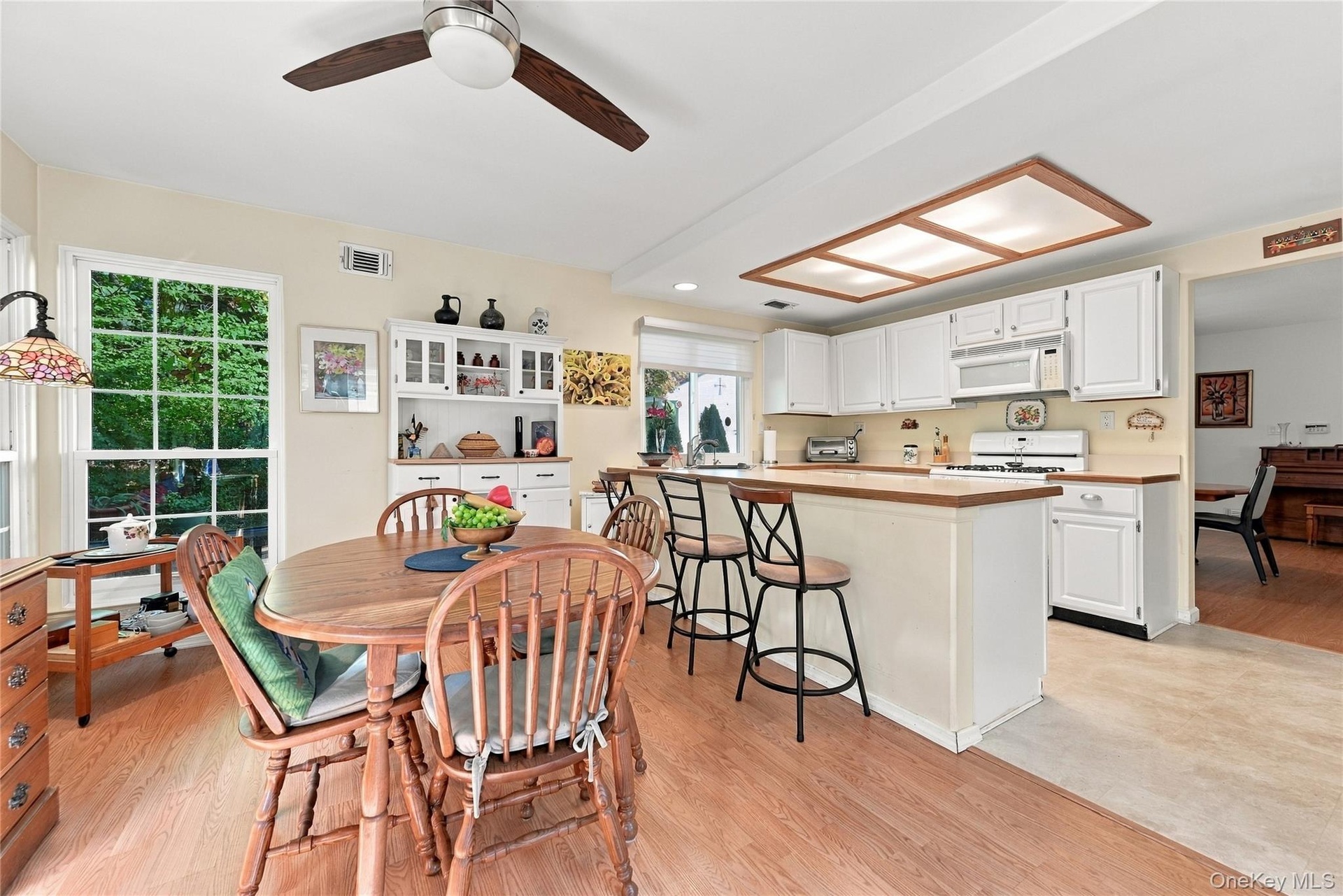 Between The Eat In Kitchen & The Leisure Room Is A Breakfast Bar & Barstool Area - Perfect For A Quick Bite And For Preparing & Serving Meals. The Lei