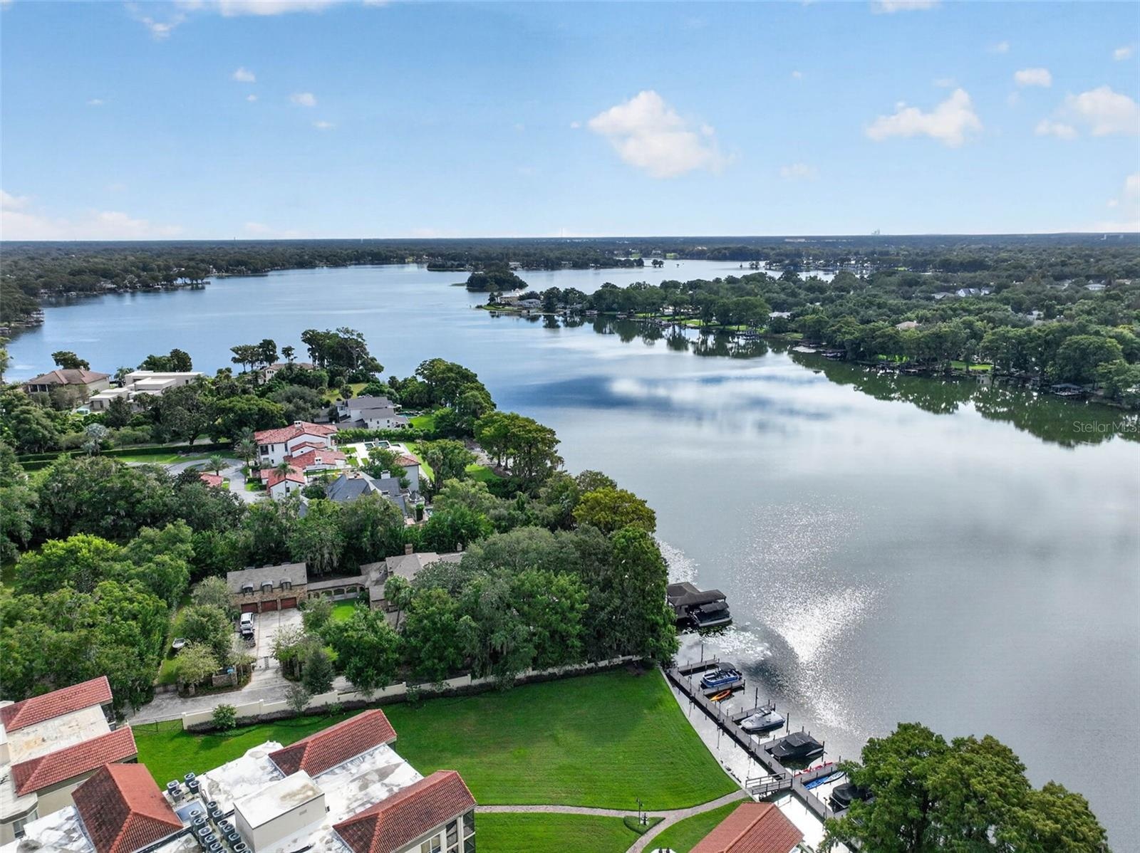 LAKEFRONT AERIAL SHOT WITH COMMUNITY GROUNDS + PRIVATE BOAT SLIPS / DOCK