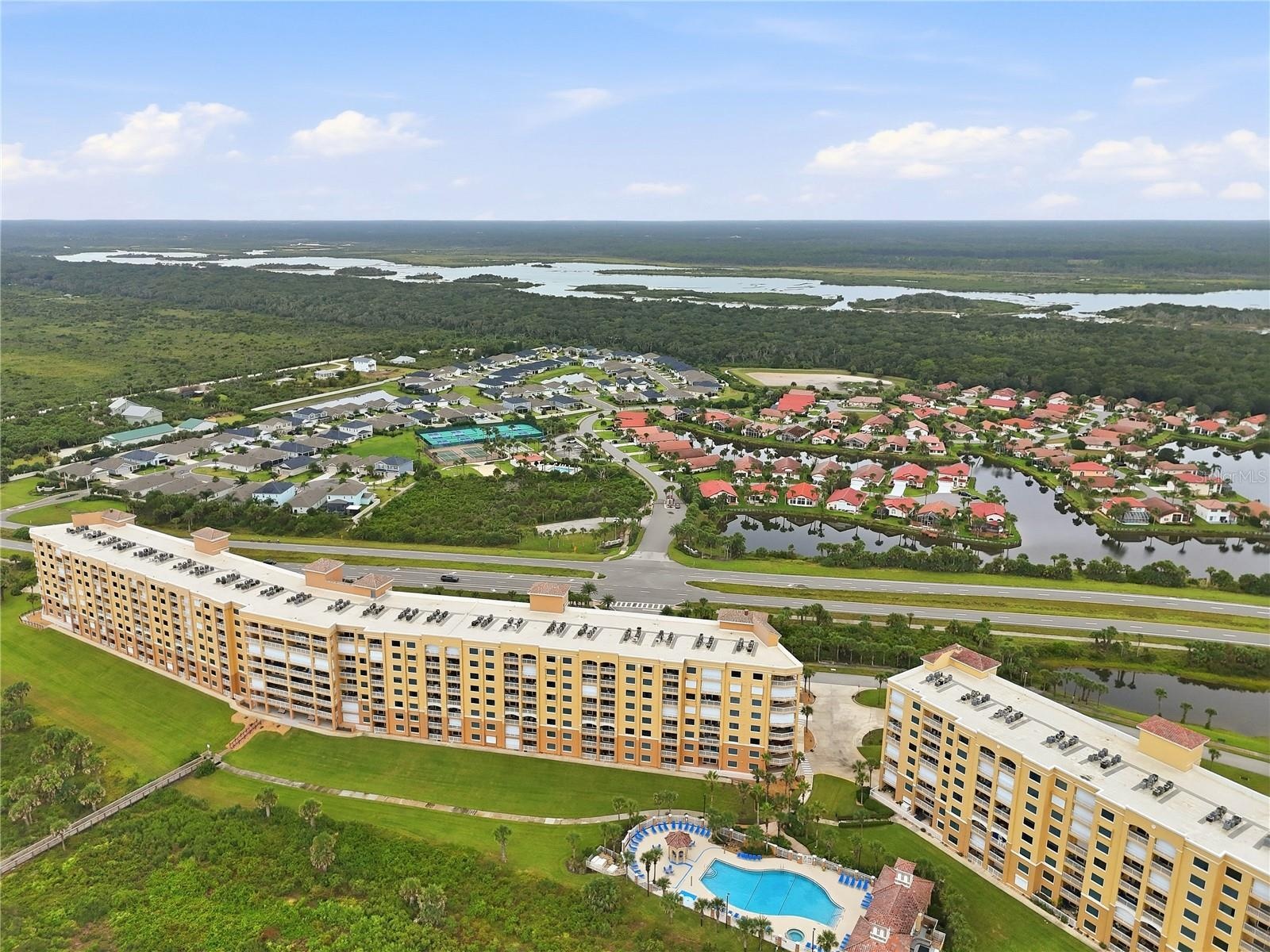 Resort amenities from the air — courts, pool, and the intracoastal beyond.