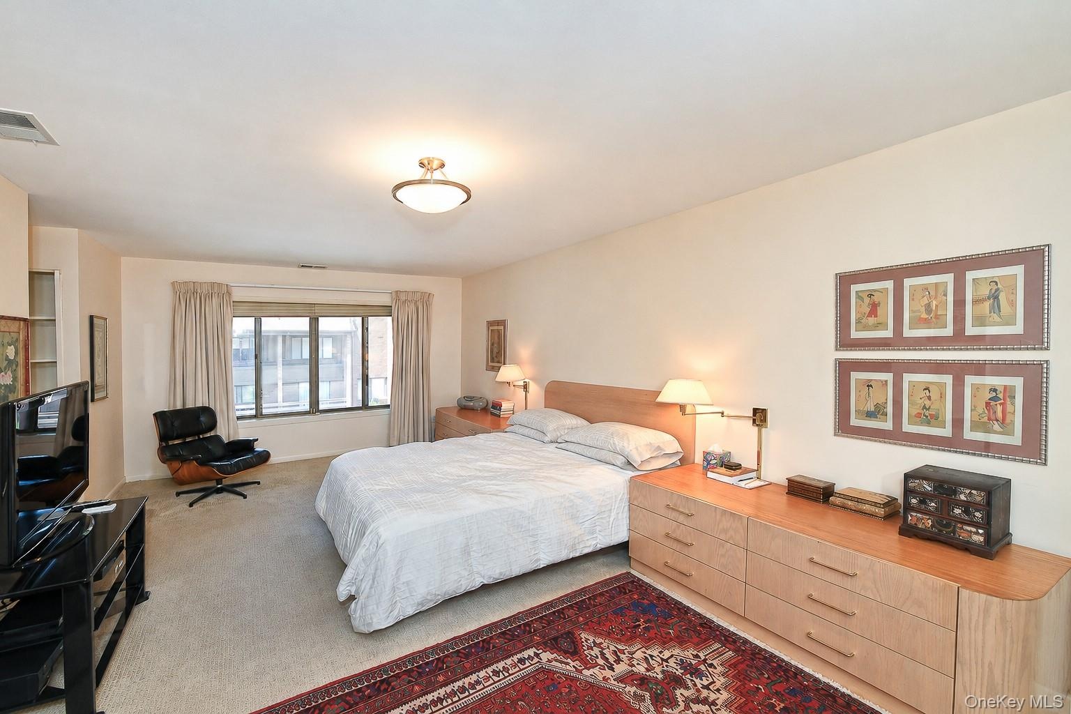 Large primary bedroom ensuite with lots of closet space, and full bathroom