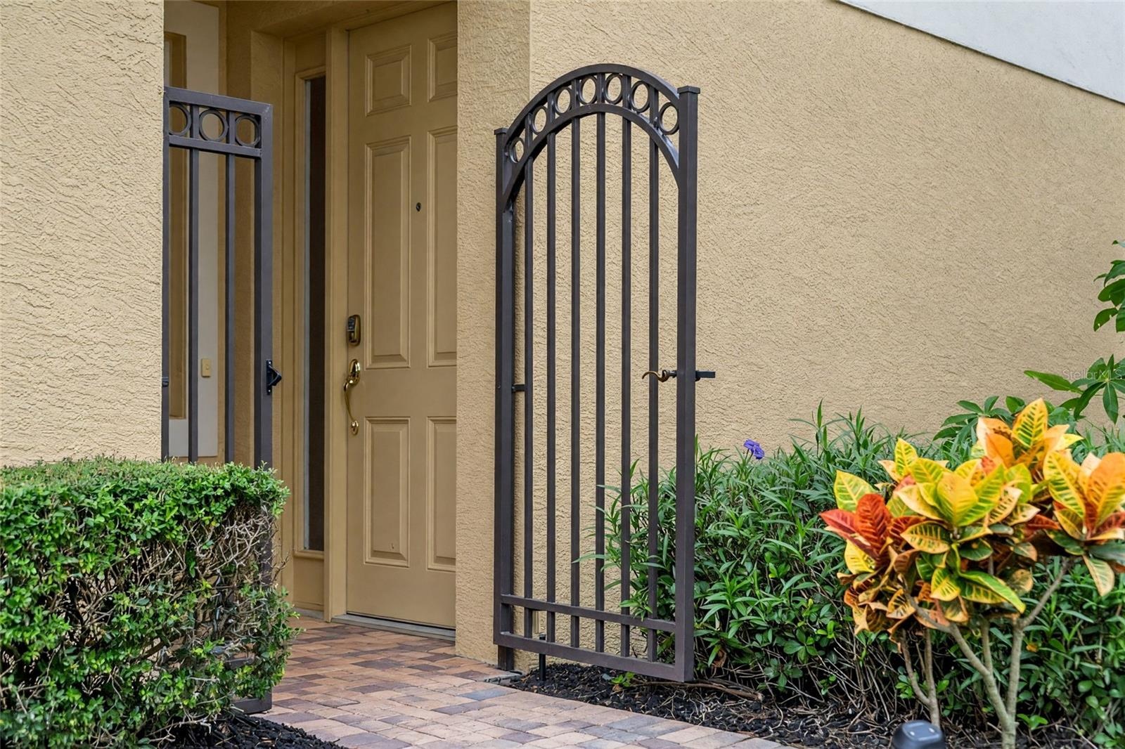 A tucked-away gated entrance adds privacy and a convenient spot for deliveries.