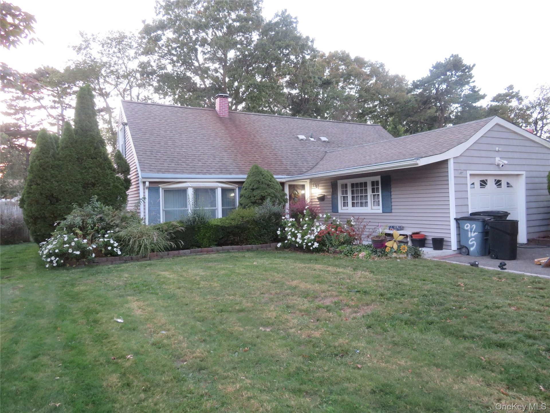 Gray shingle siding with a front-facing attached garage