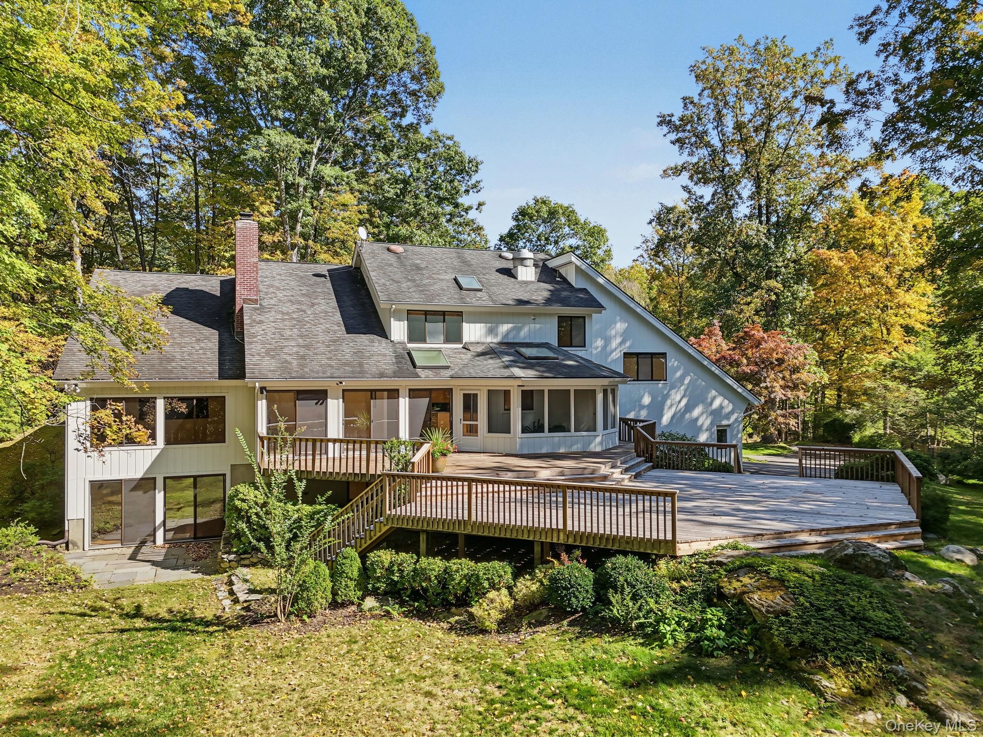 Expansive deck surrounded by nature, offering generous space for outdoor dining, entertaining, and relaxation.