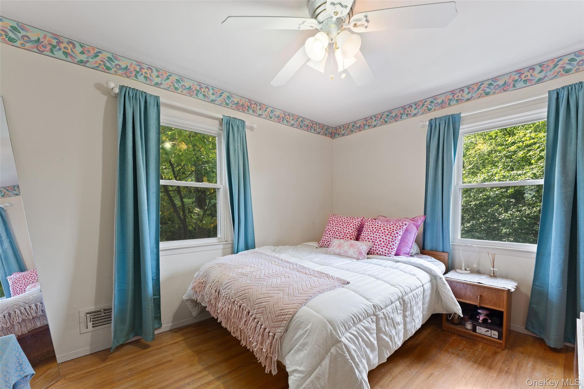 Hardwood flooring, dual windows and ceiling fan.