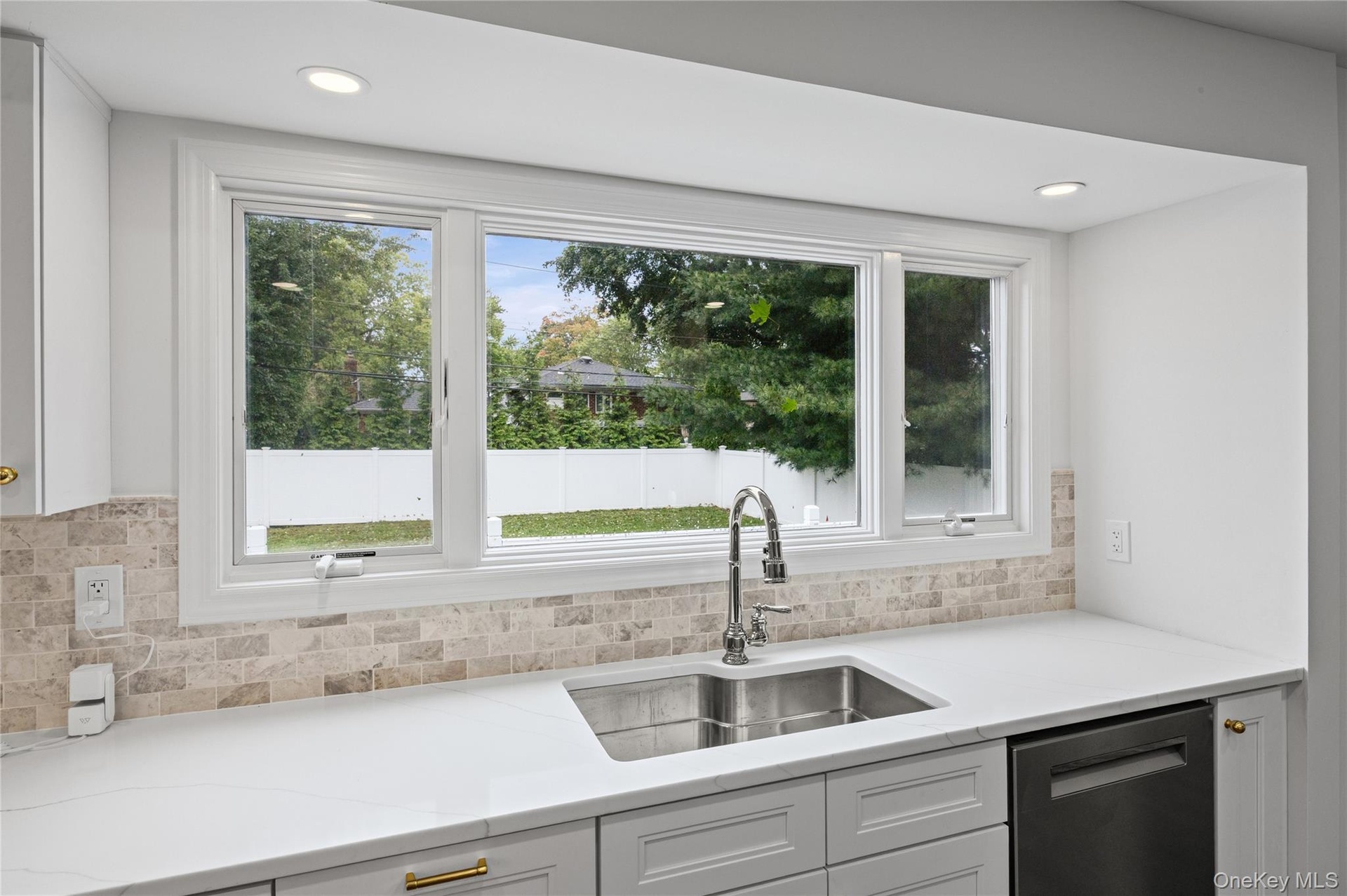 Large picture window overlooks the yard.