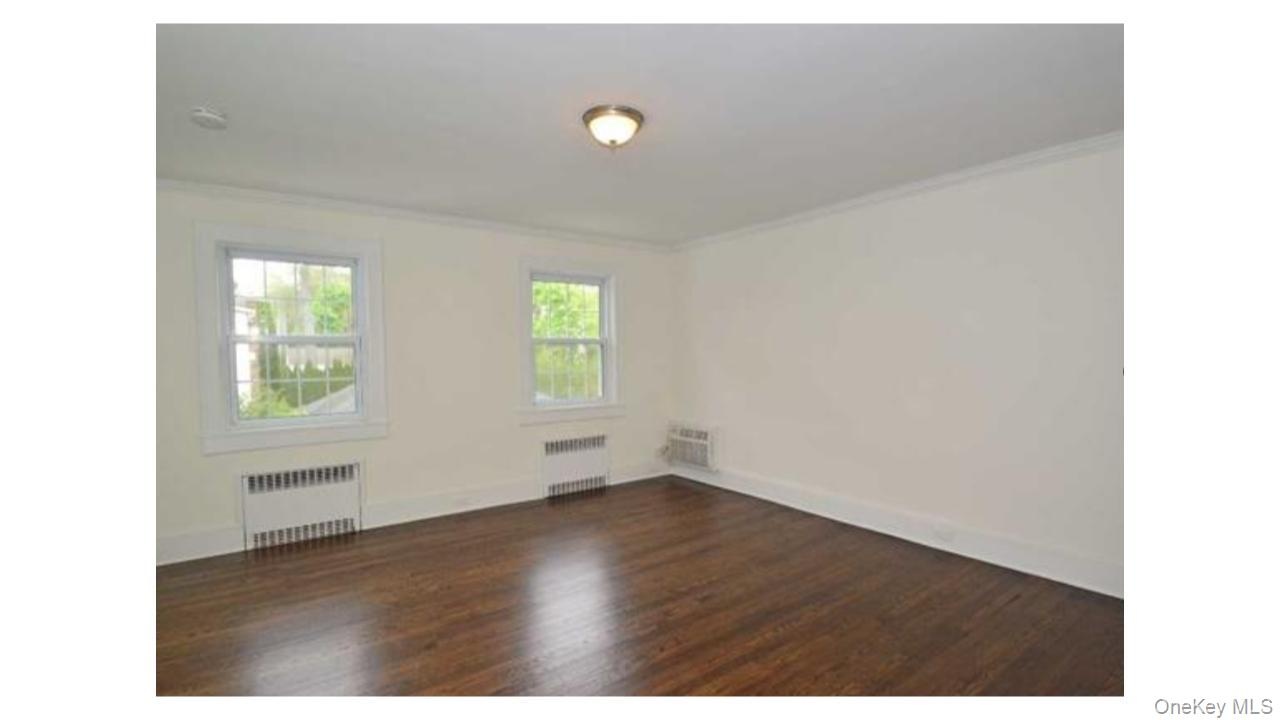 Dark wood-finish flooring with white trim