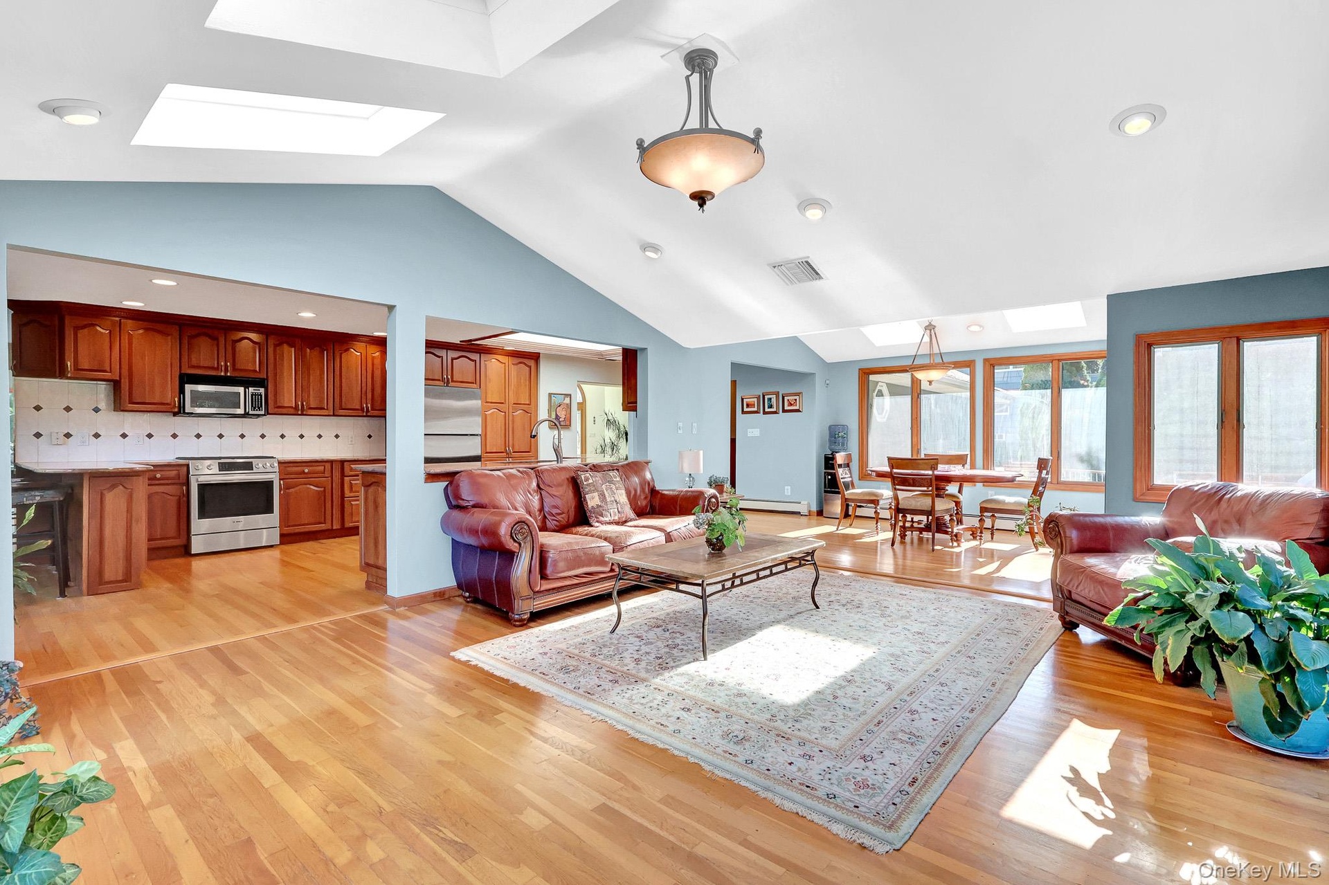 den with aliding doors onto patio & SKYLIGHTS