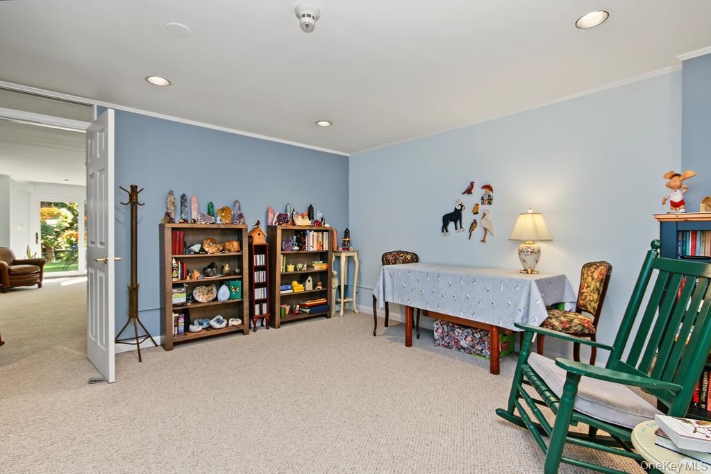Library on lower level has wall to wall carpet