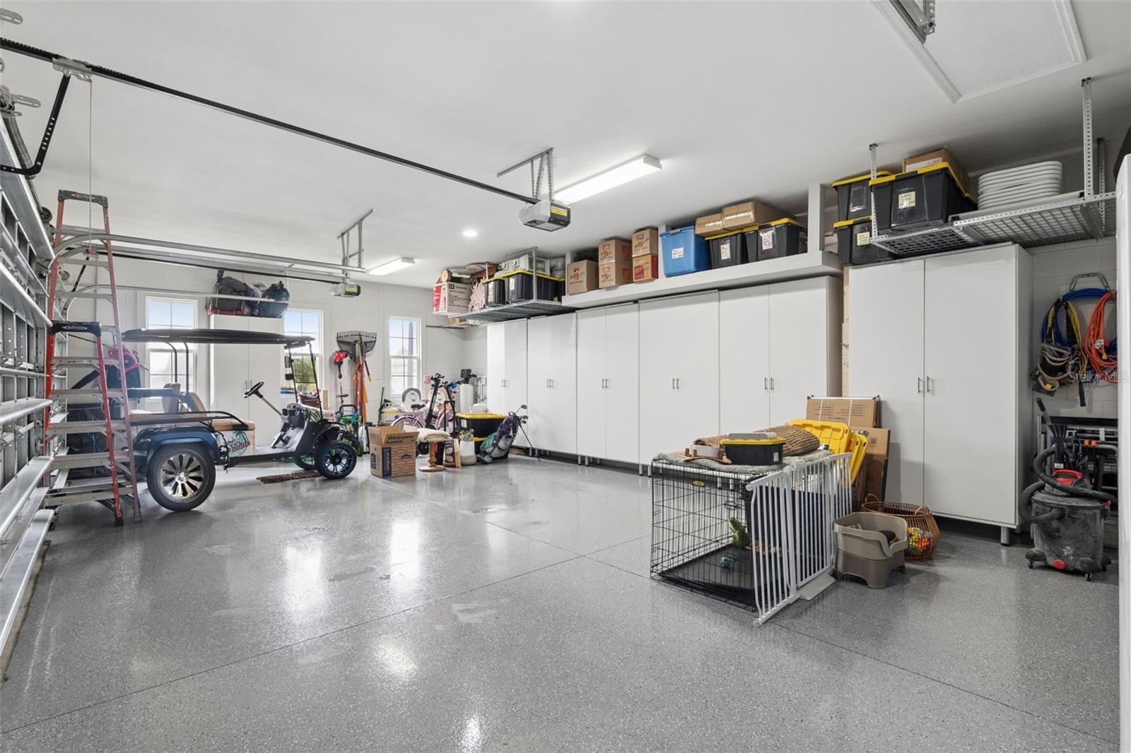 3 car garage with cabinets and tool bench epoxy floors