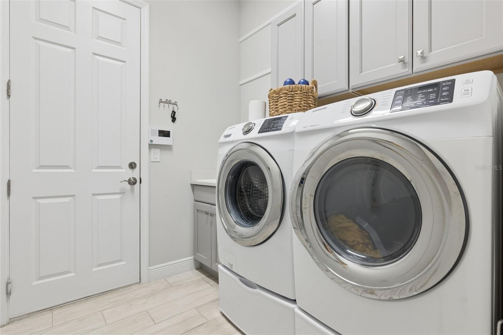 Laundry room with utility sink and cabinets