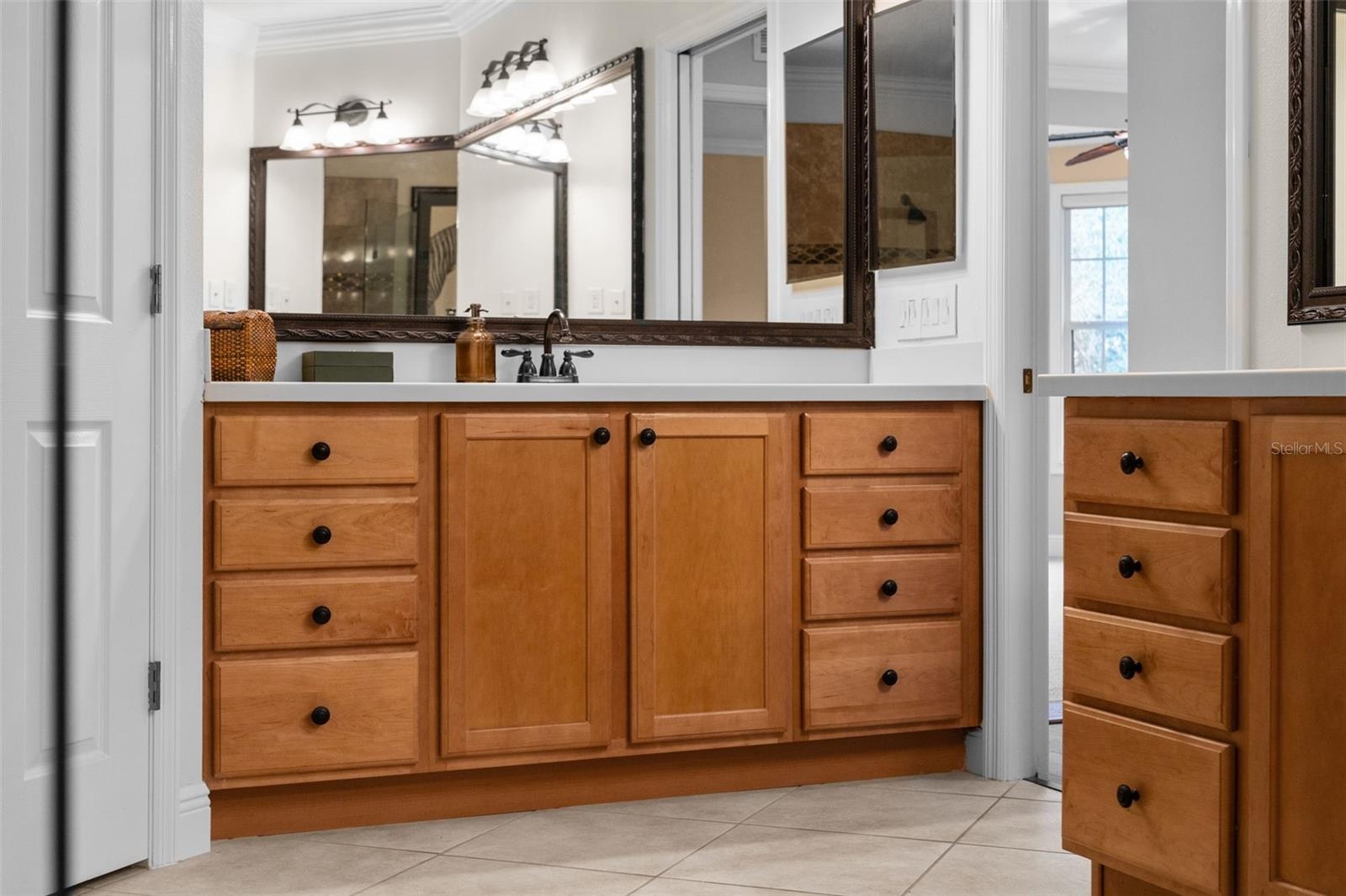 Separate vanities and abundant drawer space make sharing the primary bath easy.