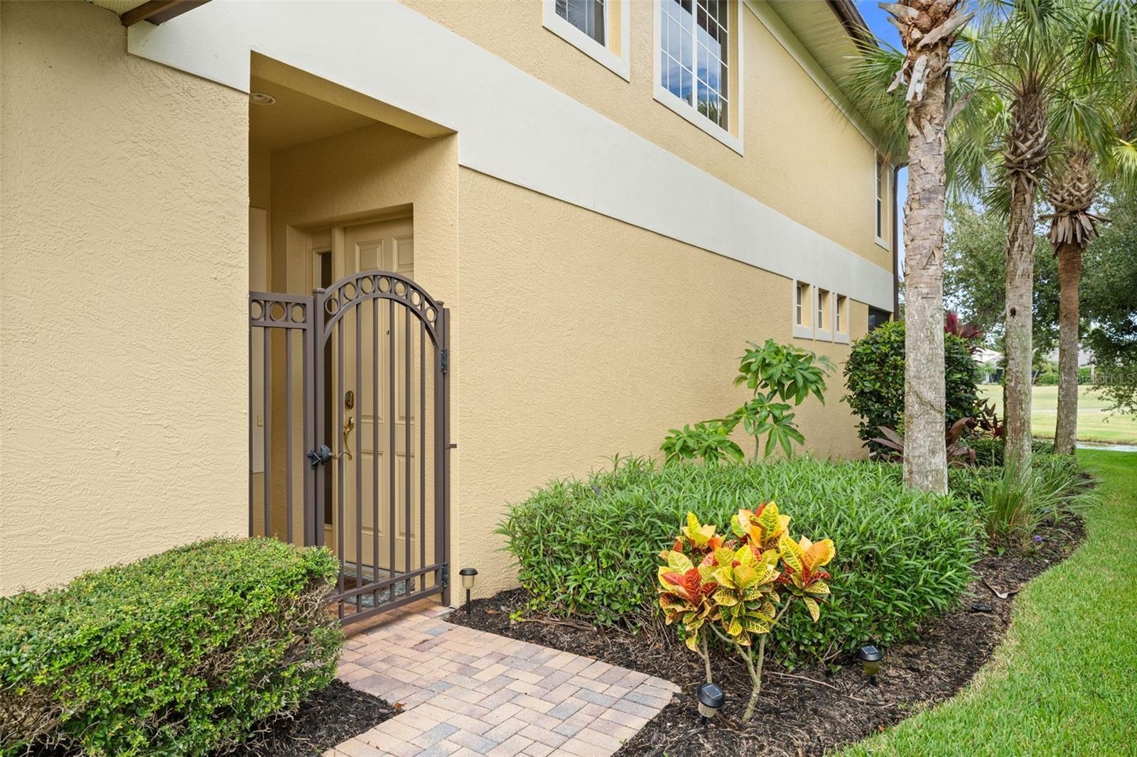 A tucked-away gated entrance adds privacy and a convenient spot for deliveries.