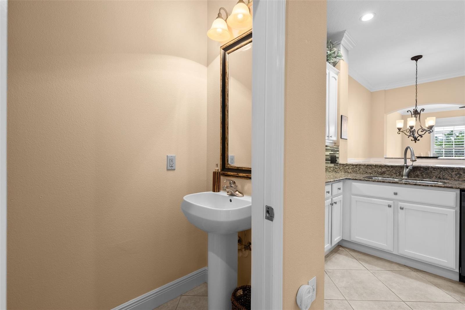 A conveniently located half bath just off the kitchen makes hosting guests easy.