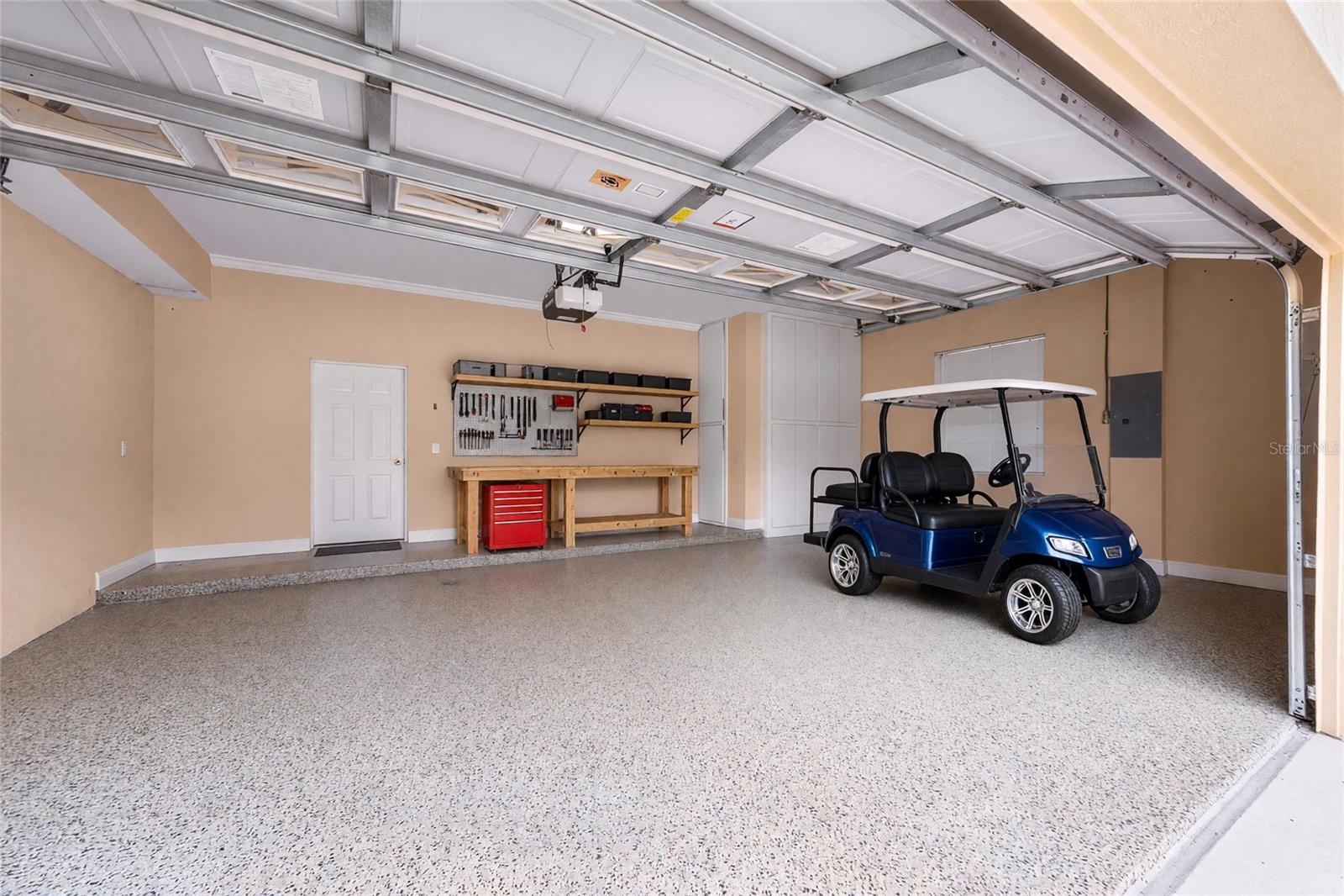 Extra built in custom storage and an epoxy-finished floor make this garage a standout feature.
