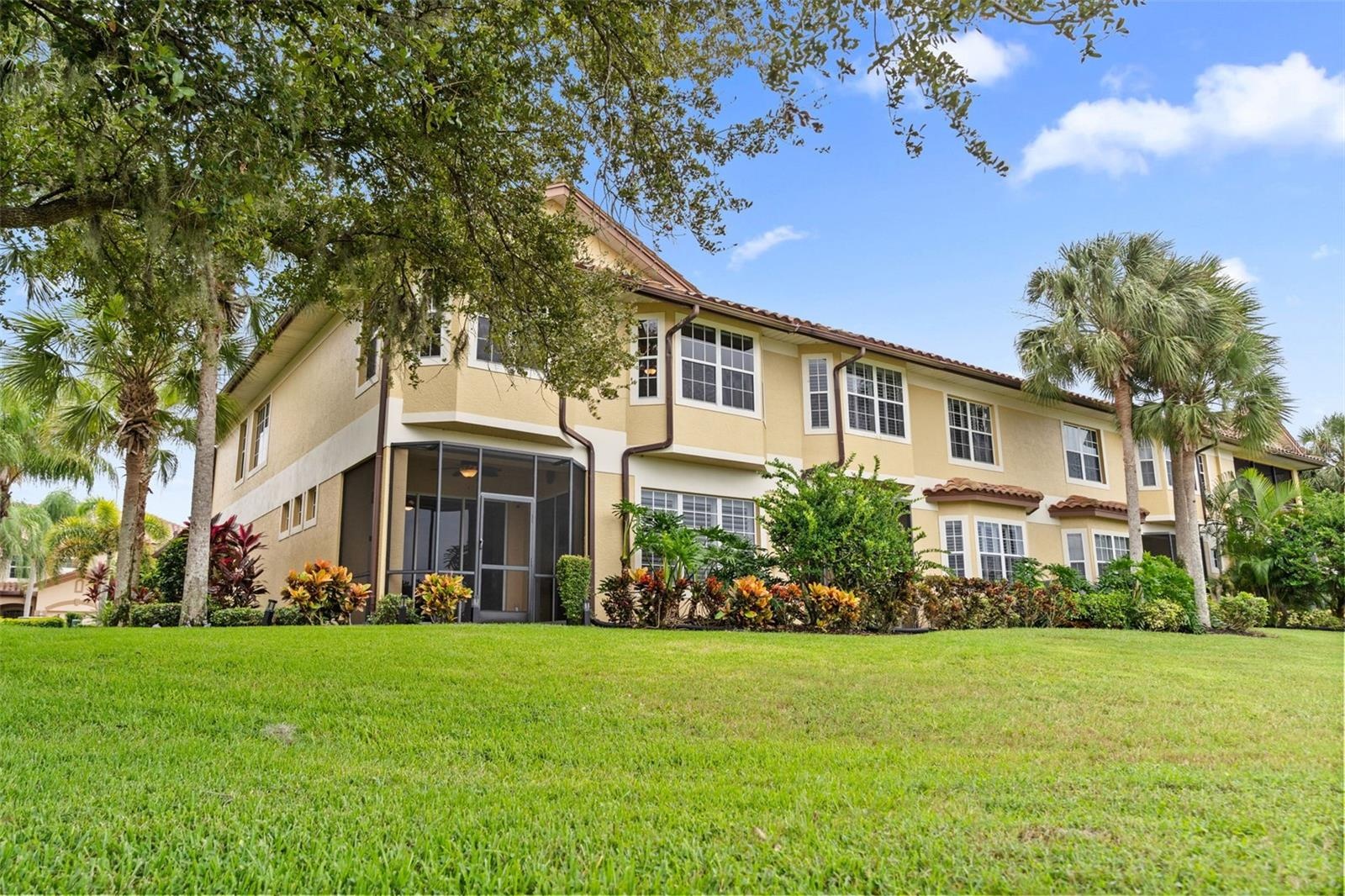 Tropical landscaping and a screened lanai create an inviting setting to enjoy the outdoors.