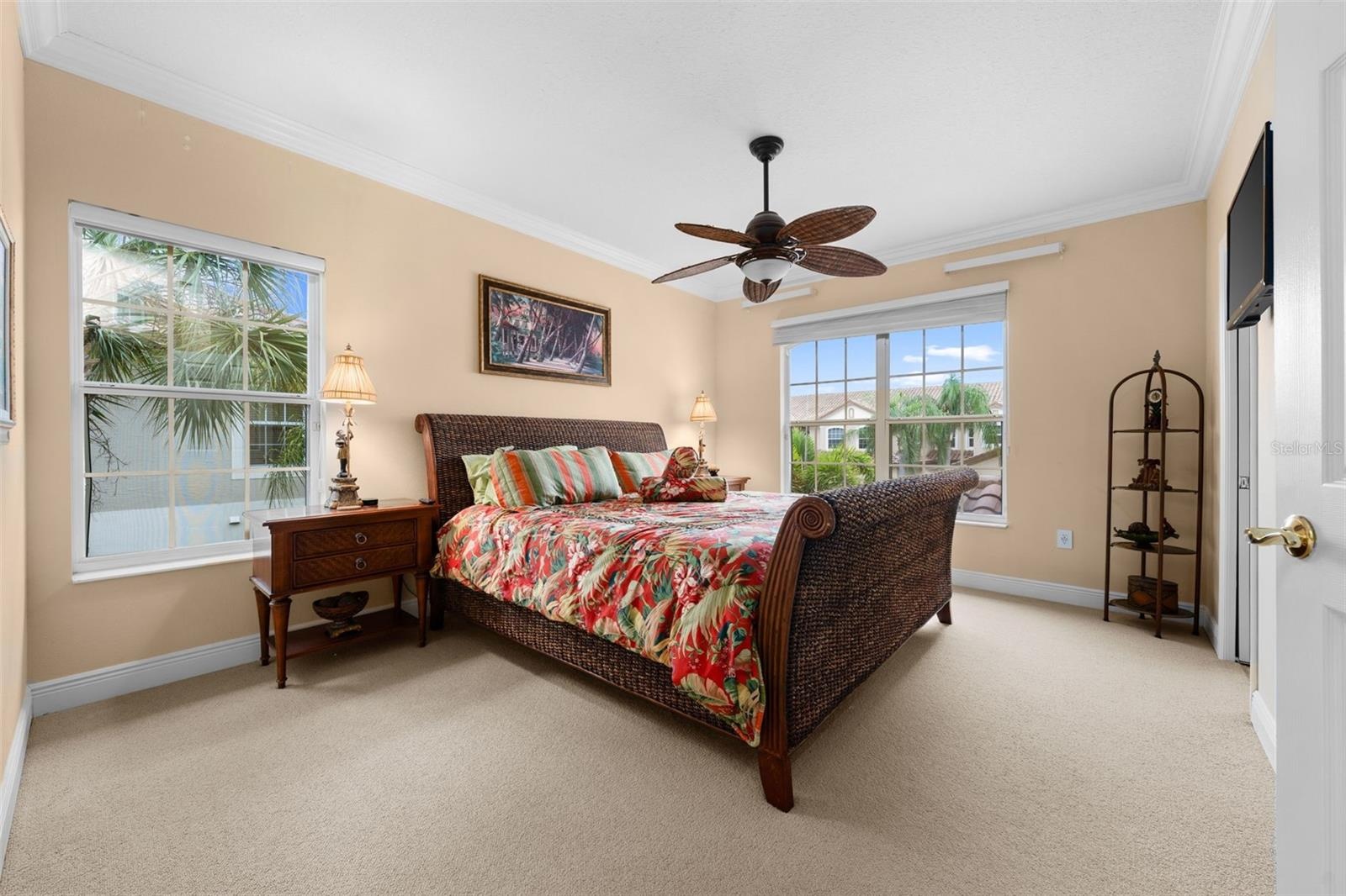 A bright, welcoming bedroom with plenty of natural light and room for overnight guests.