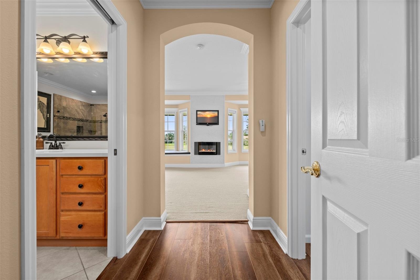 An arched entry leads into the primary retreat, with the ensuite bath close at hand.