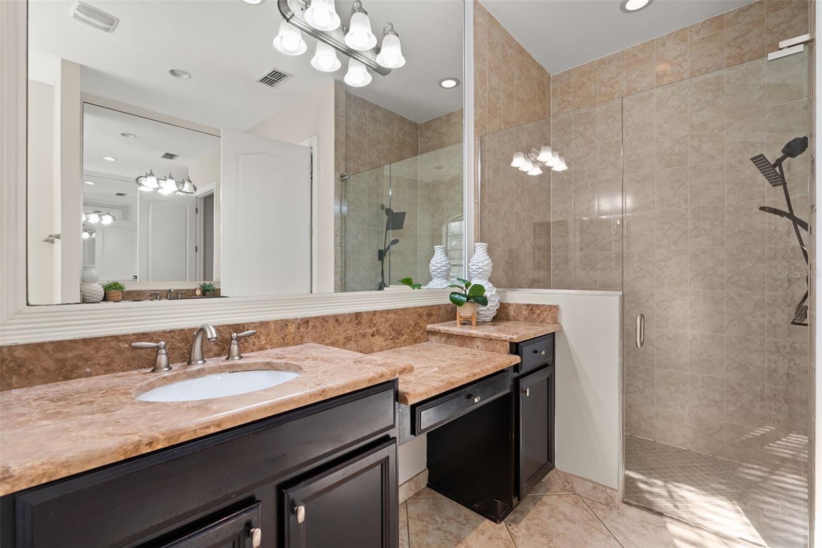 Downstairs Primary bathroom. 2 separate vanities, soaking tub, private wash closet and walk in shower