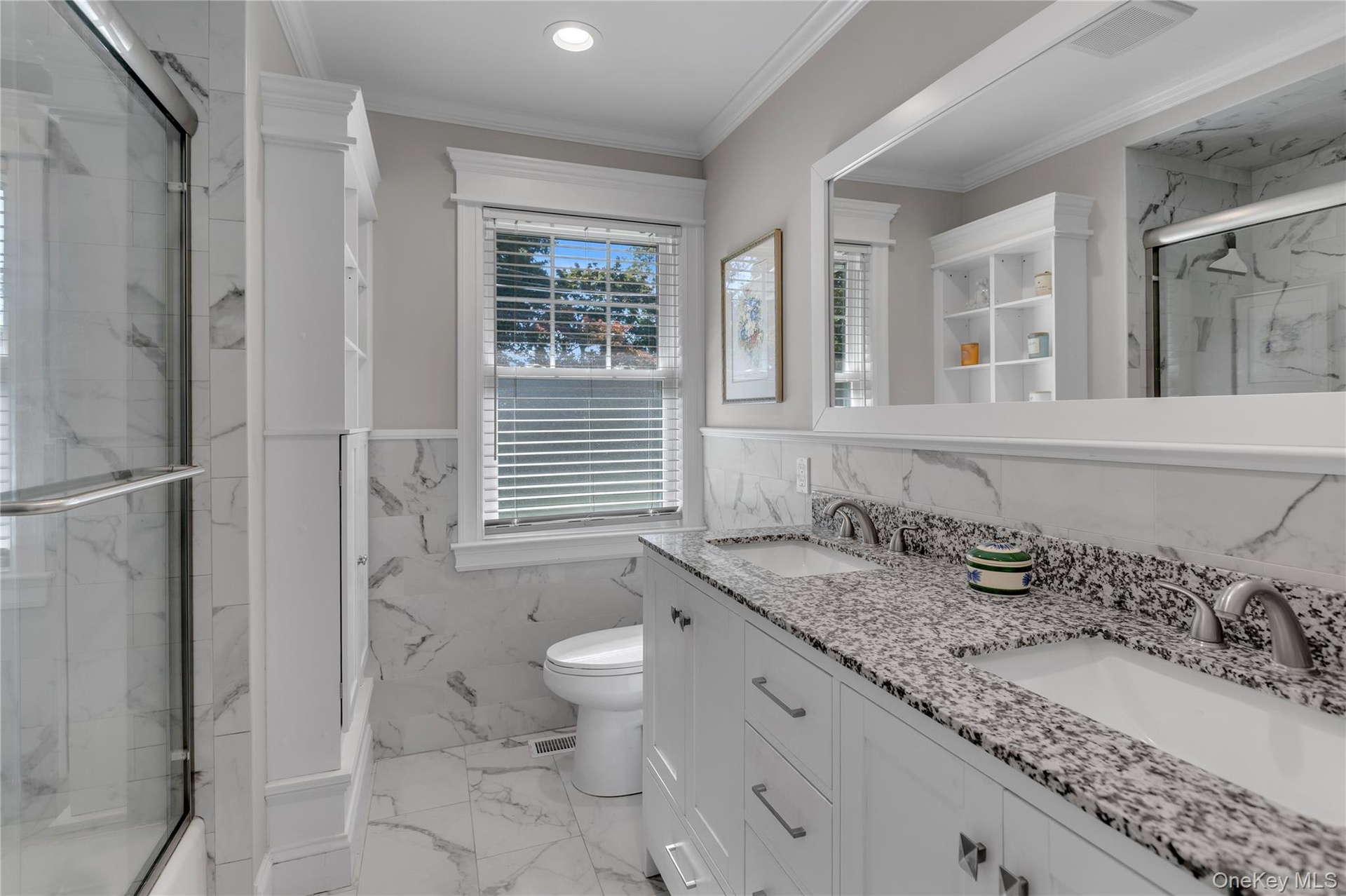 Dual vanity with granite countertops, undermount sinks, and brushed nickel fixtures