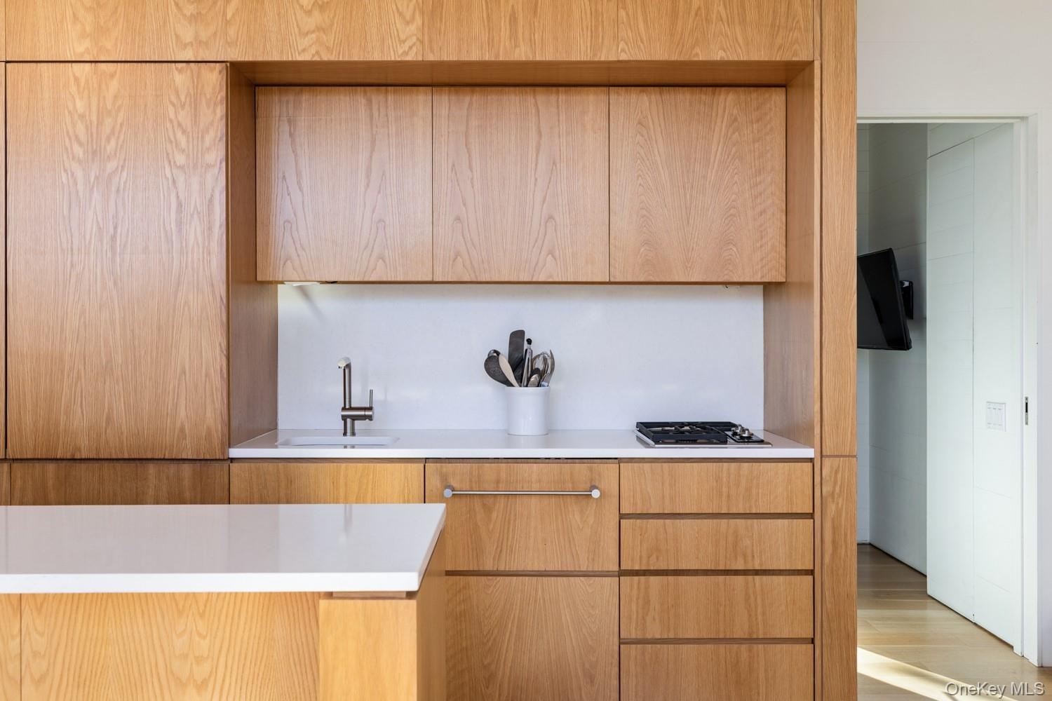 Kitchen with Gas Cooktop and Wood Cabinets