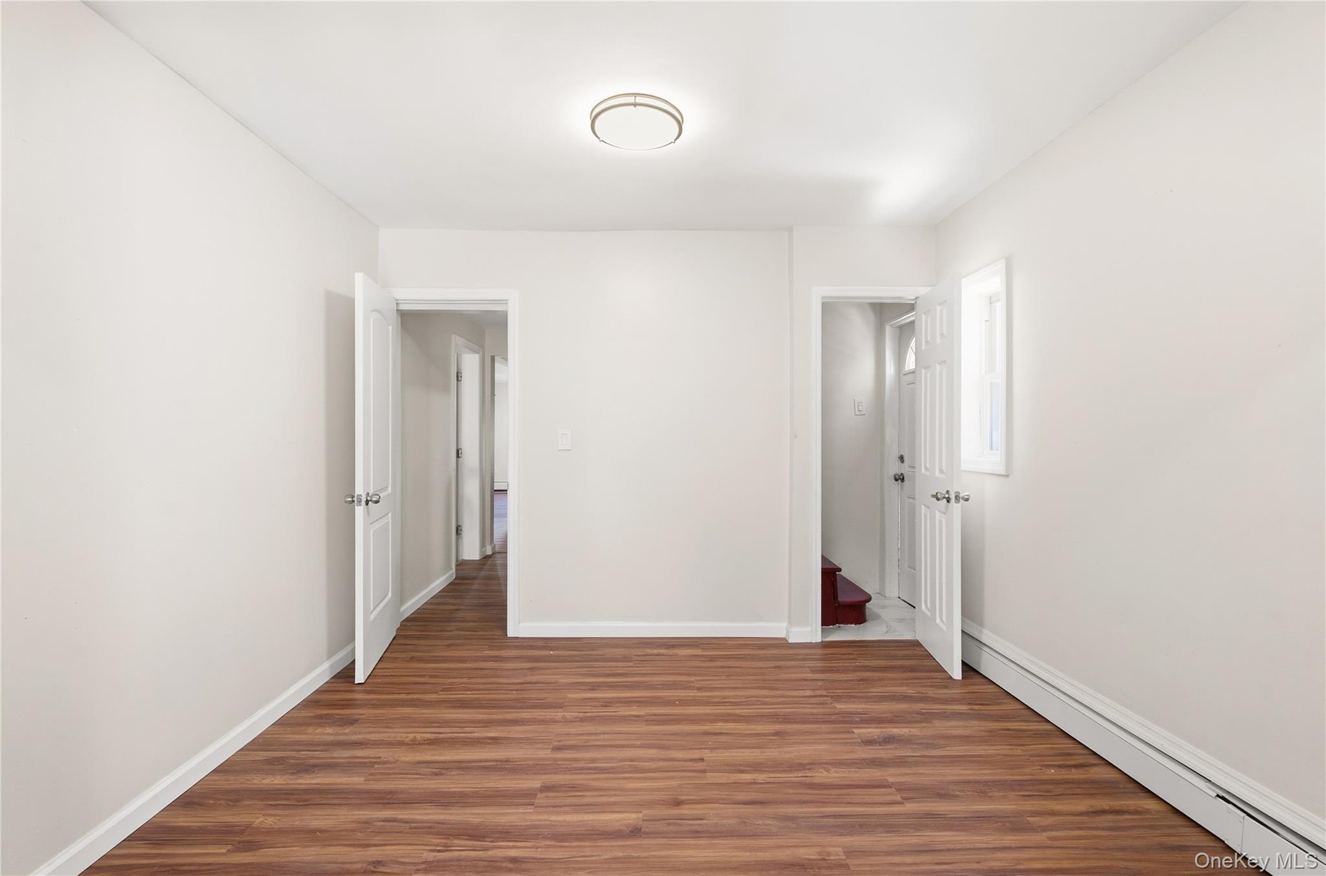 With door to upstairs and another to outside side entry