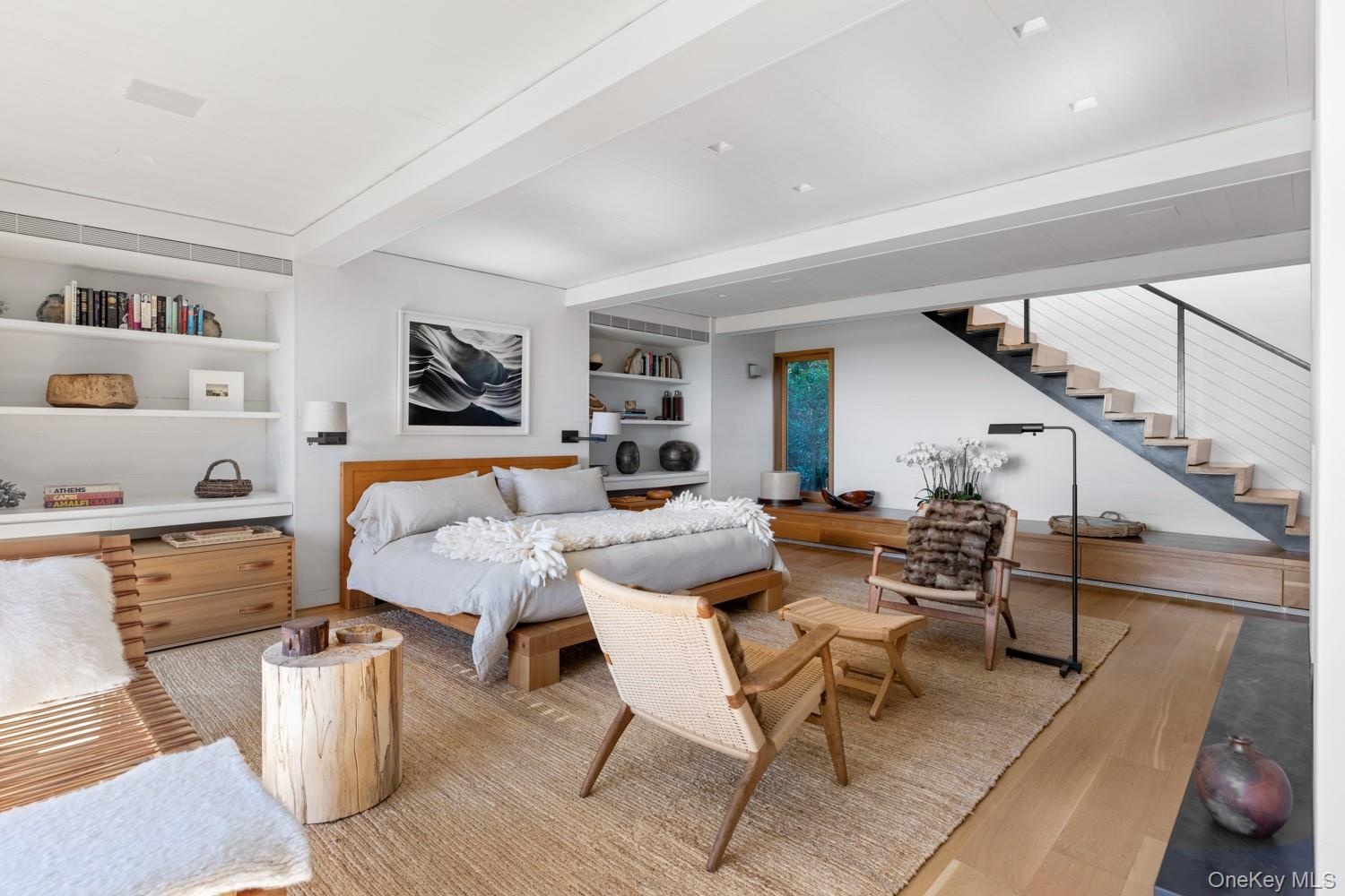 With hardwood floors, custom built-ins, gas fireplace and floating stairs to main floor