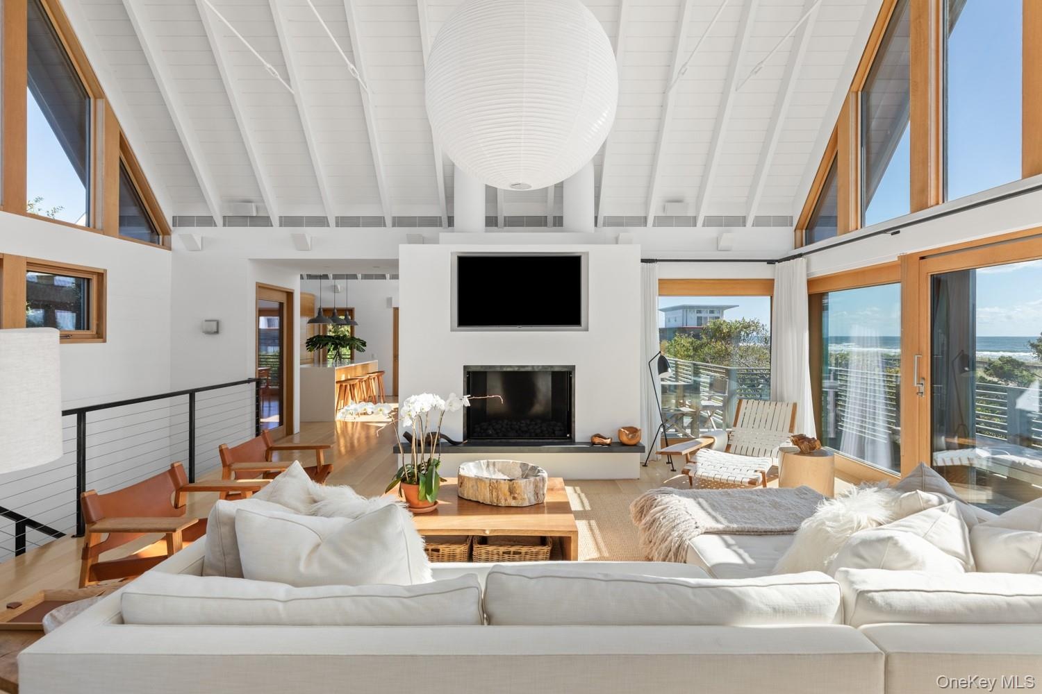 With view of the gas fireplace, ocean views, 1x6 cedar ceilings with accent hardwood pieces.