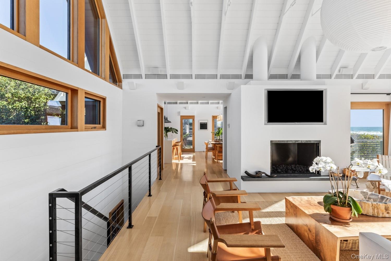With access to staircase to lower level and view of the kitchen.