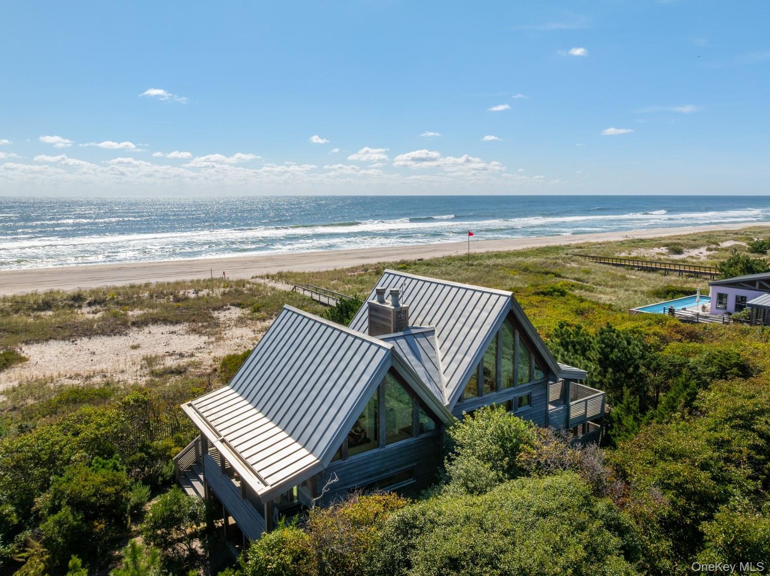 With custom made invarimate metal roof and view of the ocean.