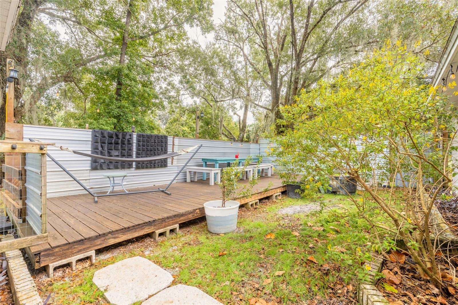 Portion of backyard fenced with deck