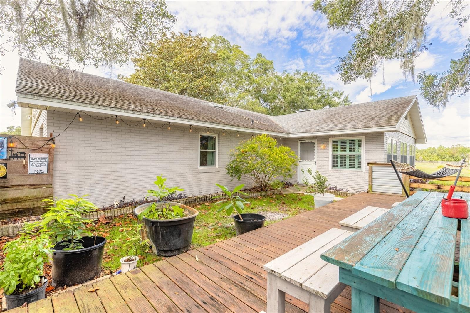 Portion of backyard fenced with deck