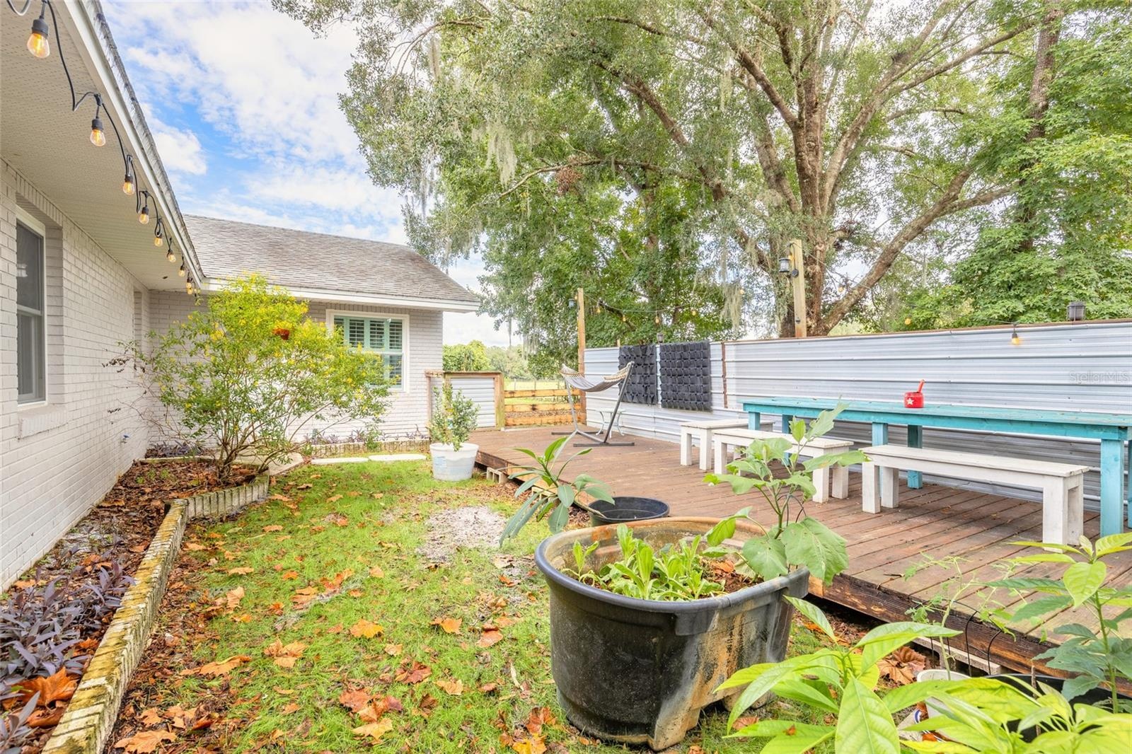 Portion of backyard fenced with deck