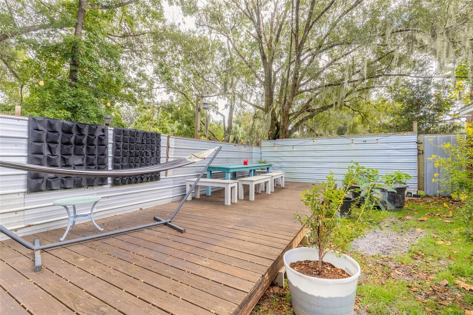 Portion of backyard fenced with deck