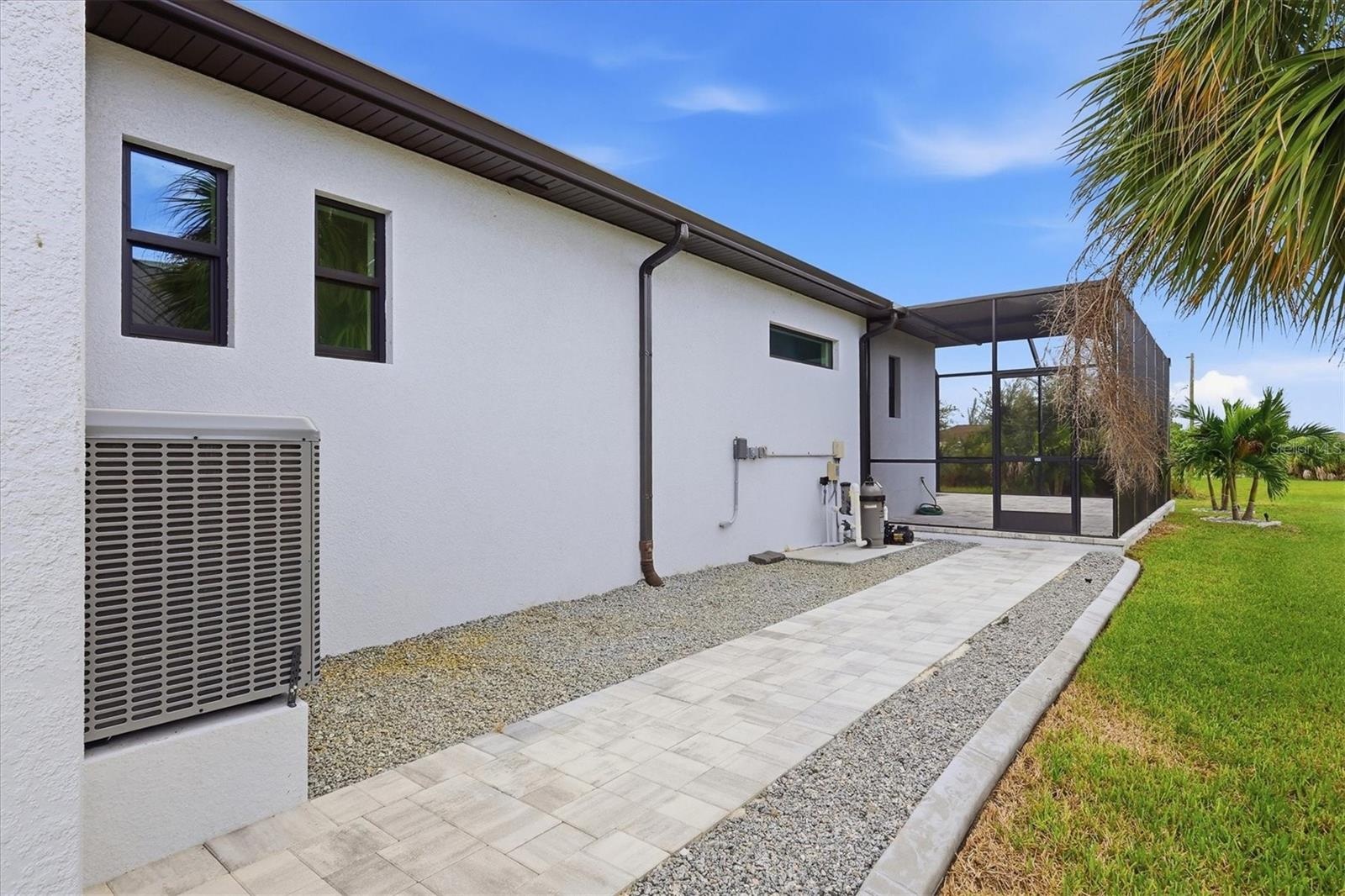 Walkway between the Garage and Lanai with enough space for a small gardening or storage shed