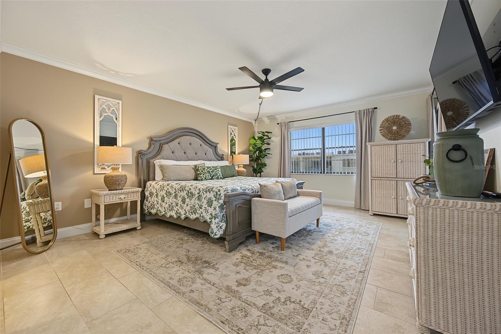 Expansive Waterfront Primary Bedroom with Sliding Glass Door to the Balcony