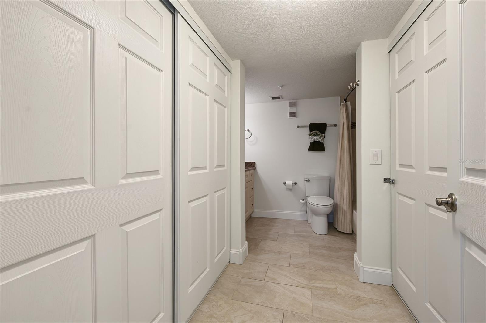 Primary bedroom walk-in closets - leading into the Bathroom