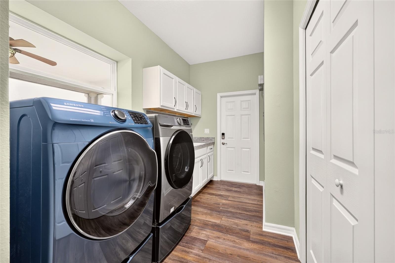 Large Laundry offers another storage closet, cabinet space, washtub, and direct access to the side yard - perfect for pets!
